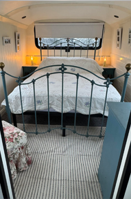 Large upstairs bedroom with panoramic Devon countryside views in The Bus on The Hill holiday accommodation.